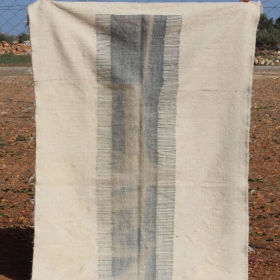 Handwoven Natural White Wool Kilim Rug with intricate patterns and a minimalist design