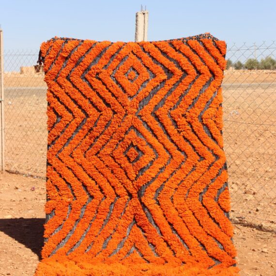 Handwoven Moroccan Rug Orange with bold abstract patterns for living room décor