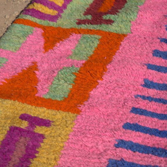 Abstract Colorful Moroccan Rug with intricate patterns in vibrant hues, displayed in a modern living room