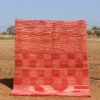 Handwoven pink rug with checkered design