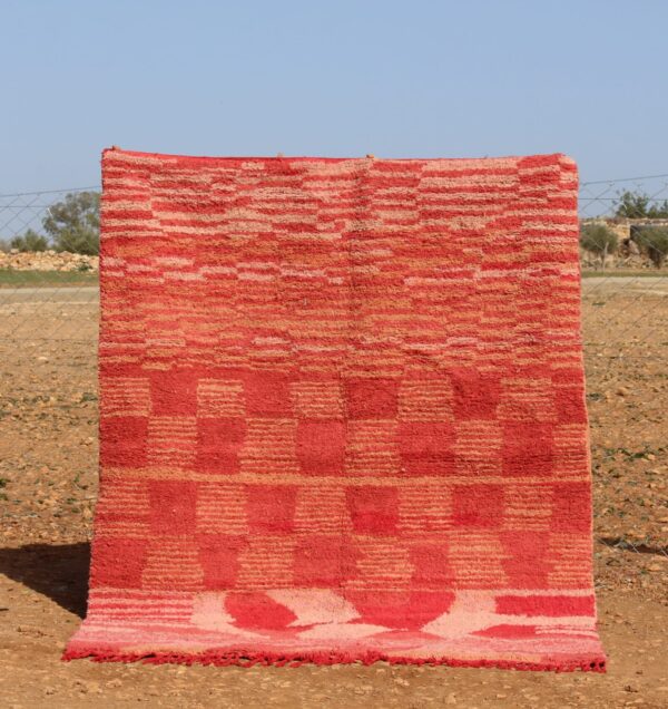 Handwoven pink rug with checkered design