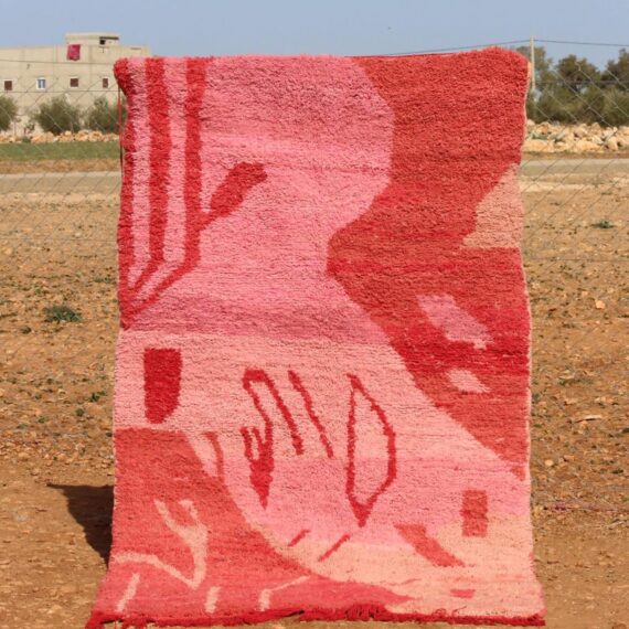Handwoven Moroccan pink rug with artistic abstract design