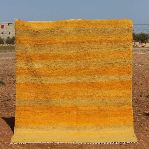 Handwoven Moroccan yellow rug with striped design
