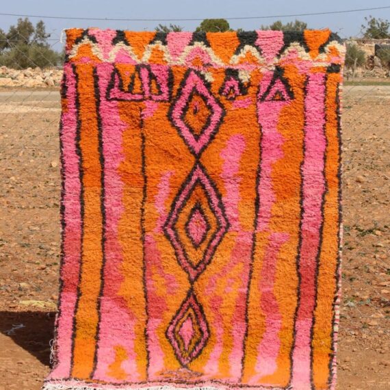 Handwoven Moroccan Berber rug with vibrant geometric patterns