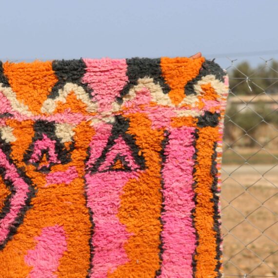 Handwoven Moroccan Berber rug with vibrant geometric patterns