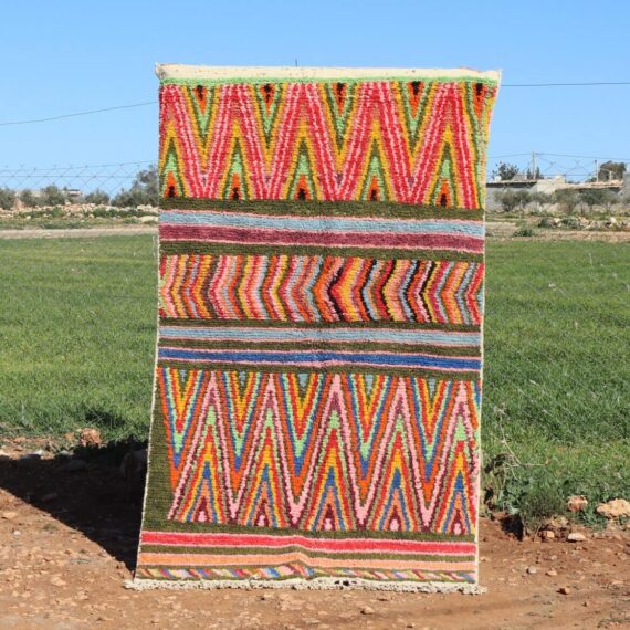 Handwoven Moroccan Berber rug with colorful zigzag patterns