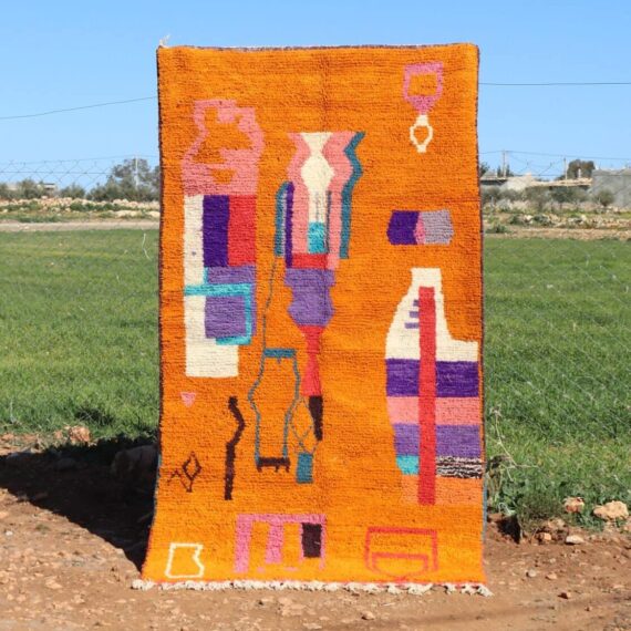Handwoven Moroccan orange rug with abstract geometric design