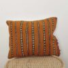 Moroccan striped kilim pillow in orange with handwoven Berber design
