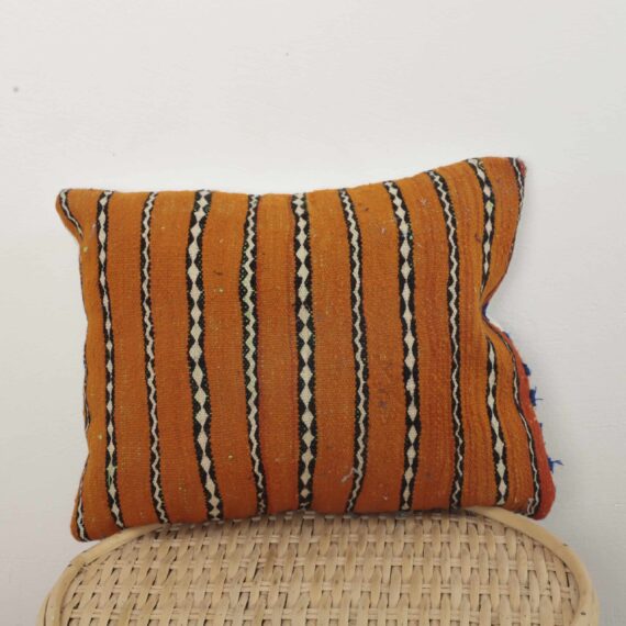 Moroccan striped kilim pillow in orange with handwoven Berber design