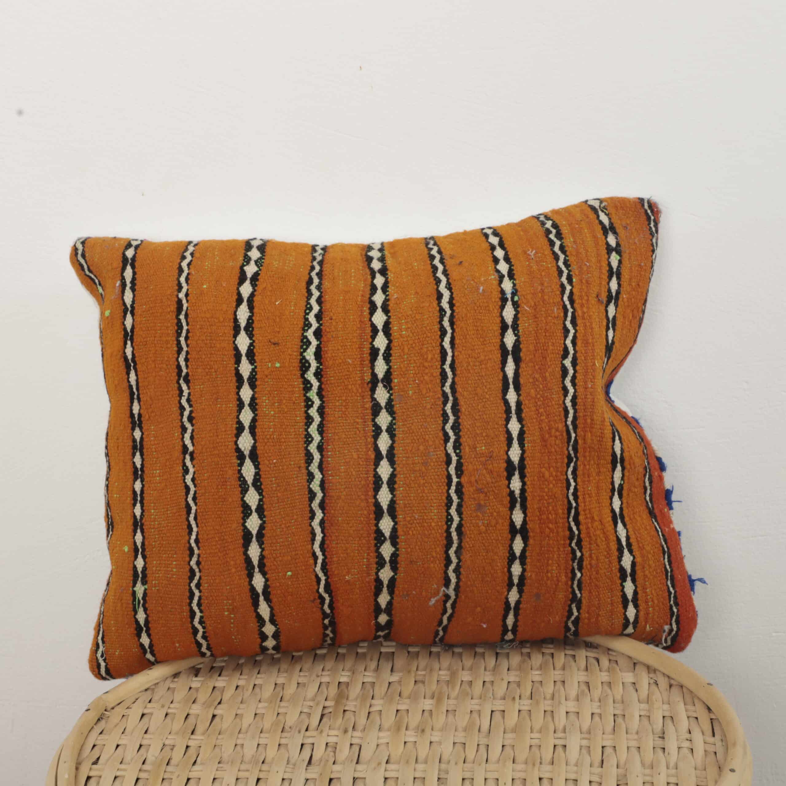 Moroccan striped kilim pillow in orange with handwoven Berber design